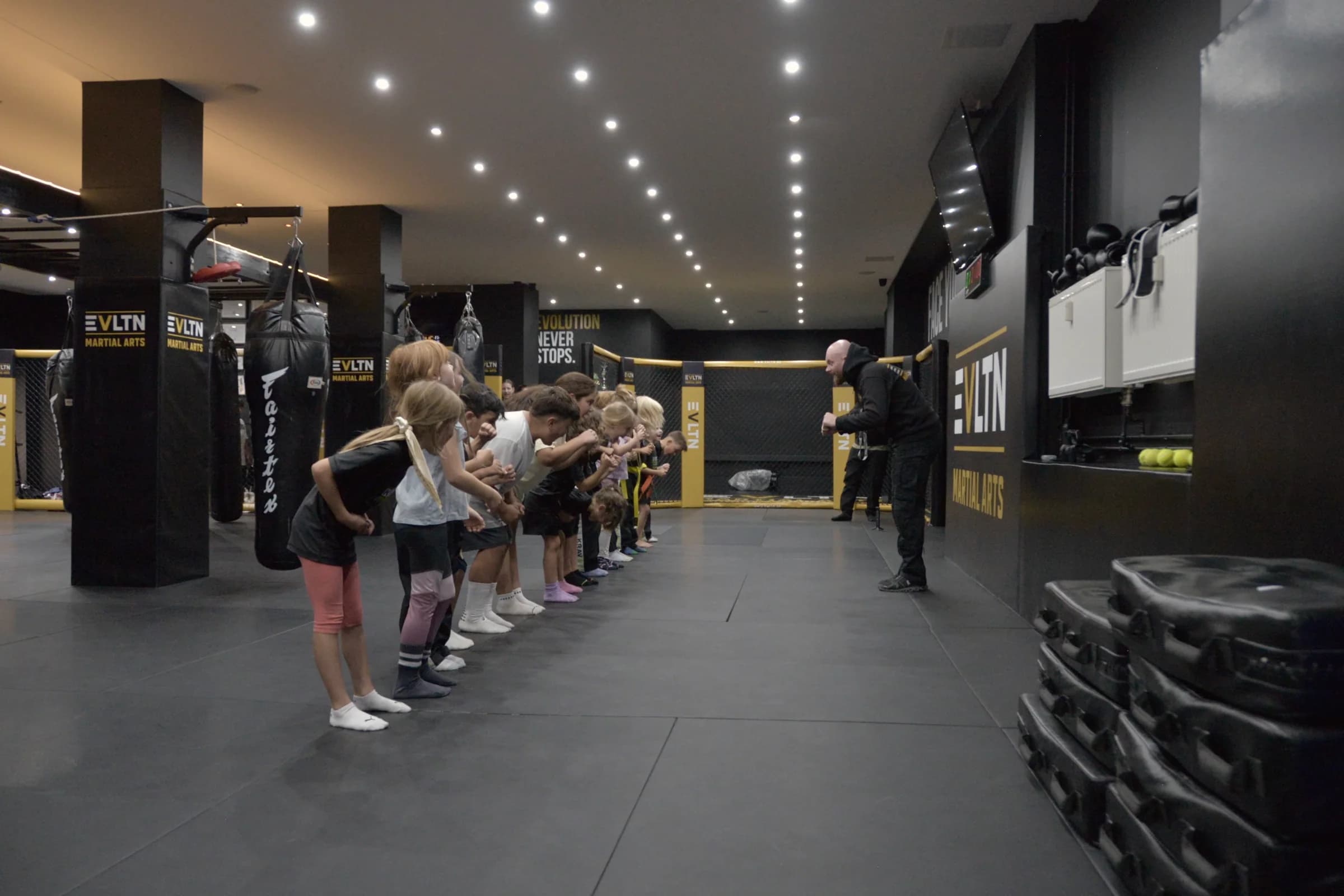 Kinder trainieren gemeinsam mit ihrem Trainer bei EVLTN Martial Arts